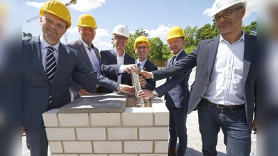 Eine Zeitkapsel mit der Urkunde zur Grundsteinlegung und aktuellen Zeitungsausgaben vom 15. Mai 2025 wurde von (v.l.) Jens Kronsbein (Bezirksregierung Detmold), Matthias Goeken (Landtagsabgeordneter), Leander Sasse (Geschäftsführer Stadtwerke), Bürgermeister Tobias Scherf, Staatssekretär Daniel Sieverke und Architekt Thomas Kalman in den Grundstein des Bades eingelassen. Die Kapsel soll künftigen Generationen als Fenster in unsere Zeit dienen. (Foto: Stefan Bönning)