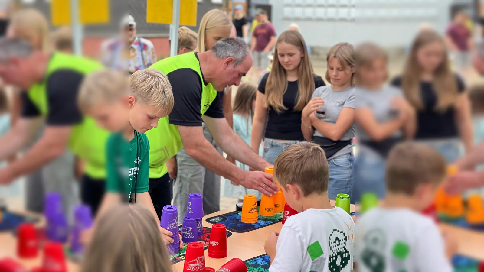 Der Aktionsstand des MTV Boffzen war immer dicht umlagert. Hier zeigt Abteilungsleiter Jörg Schilcher, wie die Becher richtig gestapelt werden. (Foto: MTV Boffzen)