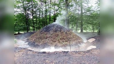 Einmal jährlich wird die alte Handwerkskunst der Köhlerei in Uslar-Delliehausen präsentiert. Das Anstecken des Holzkohlenmeilers wird mit einem Meilerfest am ersten Sonntag im Juni gefeiert. (Foto: Touristik-Information Uslar, W. Laufer)