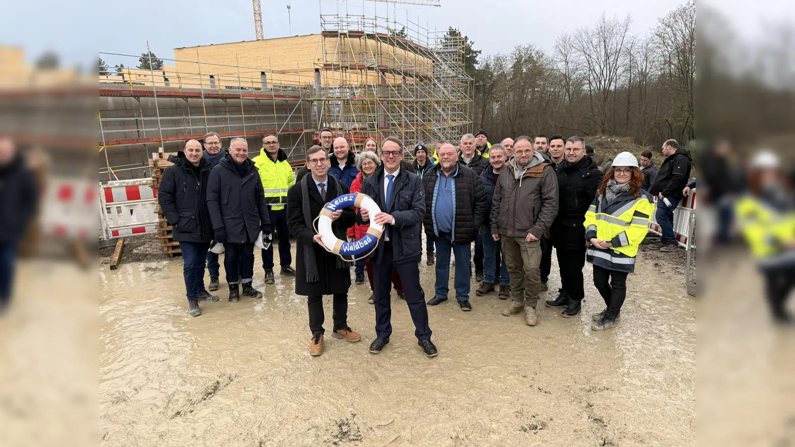 Das Neue Waldbad feiert Richtfest: Bürgermeister Tobias Scherf (vorne links) und Stadtwerke-Geschäftsführer Leander Sasse, die Mitglieder des Rates und die Bauverantwortlichen freuen sich über diesen wichtigen Meilenstein. (Foto: Stadt Warburg)
