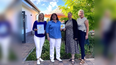 Erzieherin Nicola Rose und Kita-Leitung Ilona Kröger freuen sich über die Verleihung der Zertifizierung „Familienzentrum“ durch Regionalleiterin Kirsten Gerold. Zuvor hatte die Einrichtung mit Gemeindereferentin Christina Bolte einen Gottesdienst gefeiert. (Foto: Kath. Kita St. Franziskus)