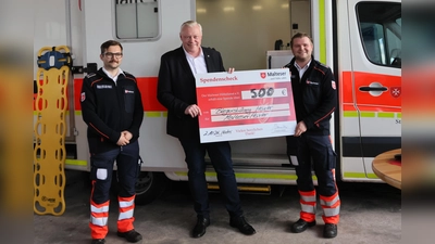 Übergabe des symbolischen Spendenscheck für die neue Fahrtrage (v.l.): David Müller-Reich, Malteser Stadtbeauftragter, Bürgermeister Daniel Hartmann und Noah Finn Schikora, Malteser Geschäftsführer. (Foto: Malteser)