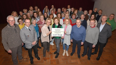 Im Vordergrund (v.l.): Heiner Wiemers-Meyer (stv. Regionalstellenleiter BwSW Höxter), OLT Markus Groß (Regionalstellenleiter BwSW Höxter), Claudia Wulf, Helga Frewer und Sabine Thomalla (CoreTeam-Mitglieder) mit dem Spendenerlösschild, Werner Humann (Chorsprecher), Rainer Löhr (Chormanager) und Volker Schrewe (Chorleiter). (Foto: Thomas Kube)