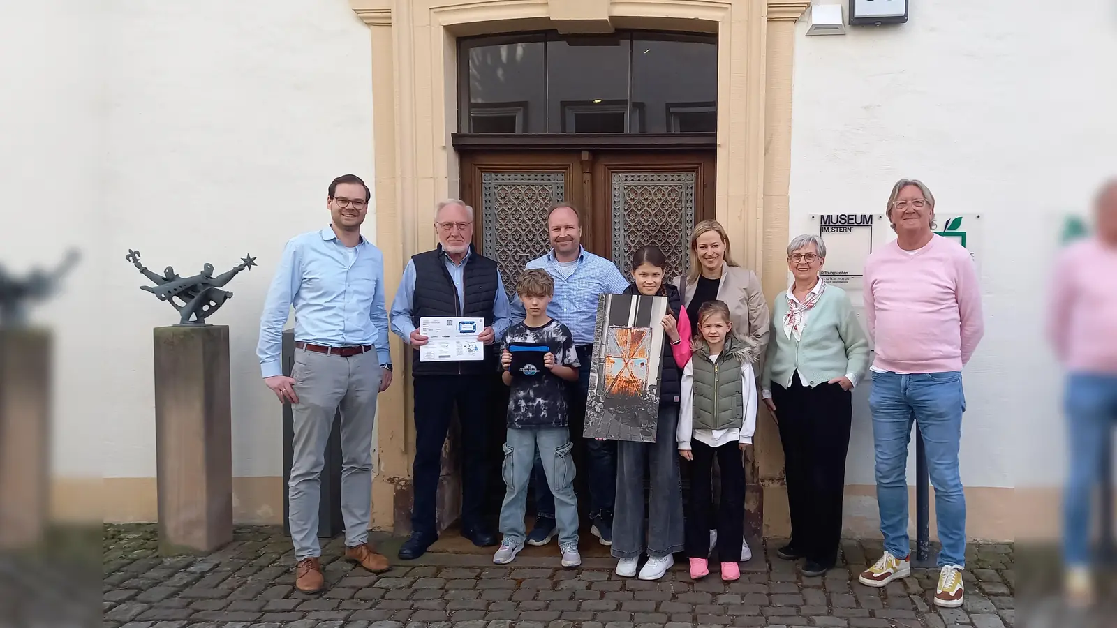 Die stolzen Gewinner des Traufgassen-Türen-Quiz (v.l.): Dr. Alexander Schwerdtfeger-Klaus, Werner Wieners, Hendrik Wieners, Frank Wieners, Charlotte Ahls, Denise Ahls, Annika Ahls, Mechthild Cramme und Hartmut Kleimann. (Foto: Stadt Warburg)