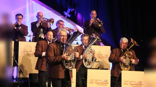 Tenorhornist und Orchesterleiter Ernst Hutter mit seinen Egerländern auf der Bühne der Beverunger Stadthalle. (Foto: Kulturgemeinschaft Beverungen)
